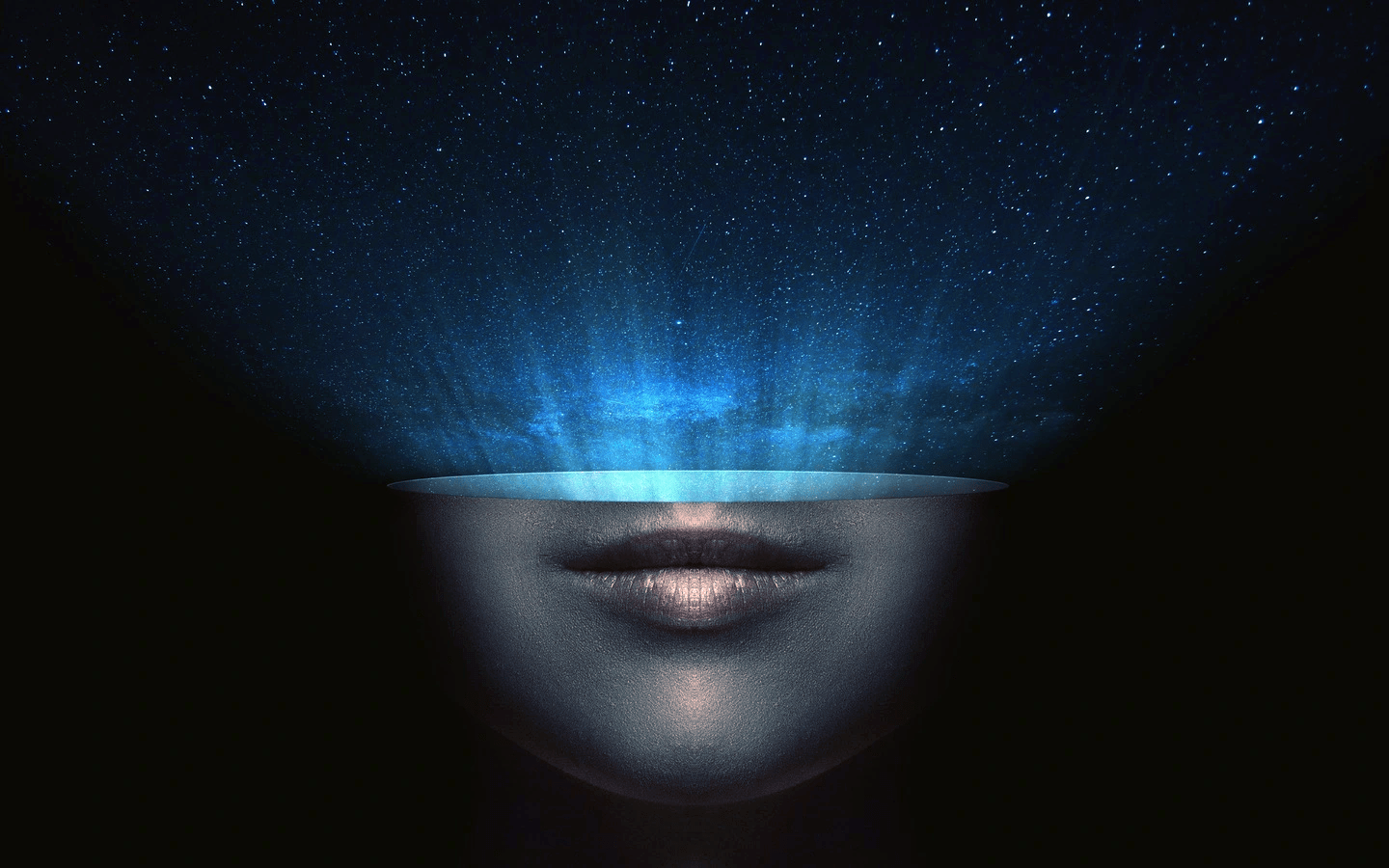 A surreal image of a head opening beneath a starry blue nebula.